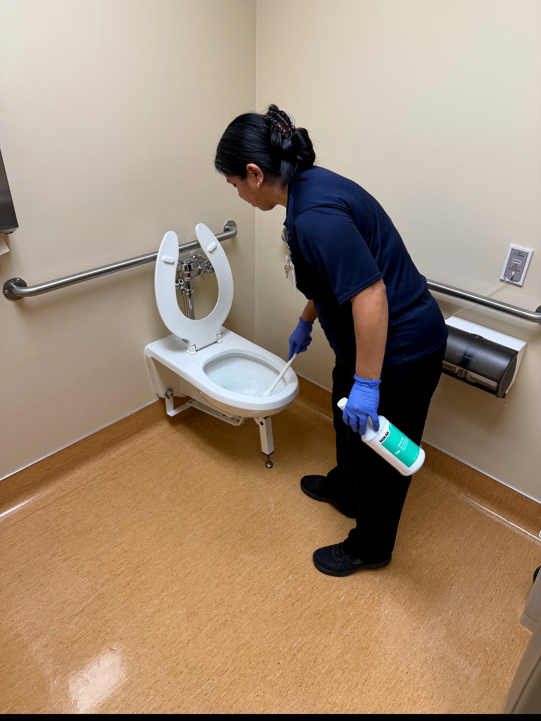 UFG team member detailing a clean restroom fixture